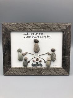 a frame with rocks in it that says, dad we love you all the little's more every day