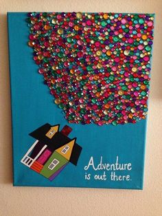 a painting on the wall that says adventure is out there with a house surrounded by colorful confetti