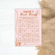 a close up of a menu on a table with a burlap bag behind it