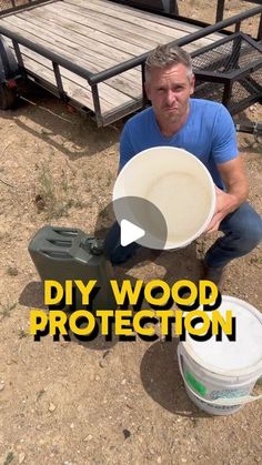 a man kneeling down next to two buckets and a trailer with the words diy wood protection on it