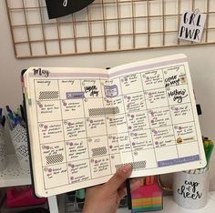 someone holding up a planner in their hand