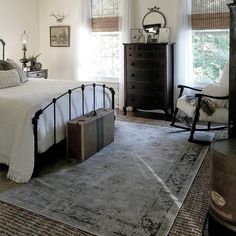 a bed room with a neatly made bed and a dresser