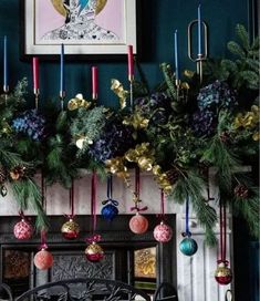 a fireplace decorated with christmas decorations and candles