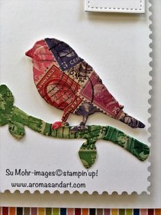 a stamp with a bird sitting on top of a piece of paper that has been cut out