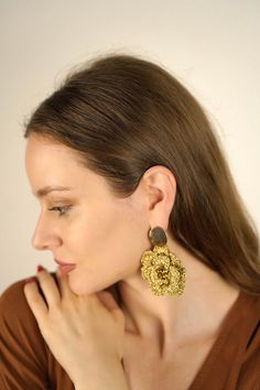 Our signature design-but grand! Bring out your inner Goddess with these stunning, majestic, three-dimensional flower earrings crocheted by hand in gold. Please note: These are handcrafted items, so each pair is unique. Expect slight variations in size. Colors may appear different due to screen and lighting variations. Also available in a smaller size. With every purchase, you support postpartum moms and babies in need in the USA. Gold-plated faceted hematite Real gold-plated brass posts Hand-cro Gold Jewelry With Handmade Flowers, Handmade Flower Shaped Gold Jewelry, Gold Flower Earrings With Handmade Details, Gold Handmade Cluster Earrings For Party, Handmade Flower Drop Earrings In Gold, Unique Gold Flower Earrings For Party, Unique Gold Flower Earrings For Wedding, Gold Flower Earrings With Handmade Details For Party, Bohemian Gold Flower Earrings Handmade