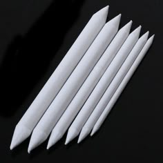 eight white cotton swabs on a black background with the ebay logo