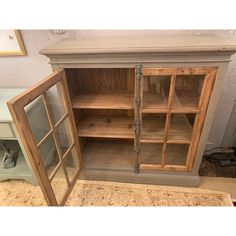 an old wooden cabinet with glass doors