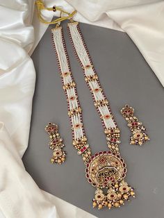 This Rajwadi Bandhai necklace is not just a piece of jewelry; it carries with it a rich heritage and cultural significance. With its timeless allure this necklace features layers of rice pearl piroyi with gold embellishments studded with colored stone tukdis, cluster & gold beads. Matching earrings included. Statement Jewelry. Perfect for any occasion.   WHAT GOES IN  👉🏻Copper Brass alloys. 👉🏻Necklace length: 26" & Drawstring Adjustable. ✅Check other styles available in our store https://www.etsy.com/shop/KKsCulture ✅ SHIPPING & TURNAROUND  👉🏻Please check item dispatch times before placing order. 👉🏻Please allow 1-2 business days for item to be dispatched. All shipments come with valid USPS tracking number.  👉🏻All pre / custom orders will take approximately 3 weeks. 👉🏻We use USP Rani Haar, Kundan Necklace Set, Kundan Necklace, Gold Embellishment, Colored Stone, Indian Wedding Jewelry, Kundan Necklaces, Jewelry Statement, Gold Beads