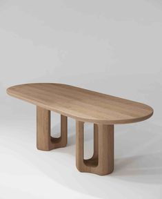 an oval wooden table with two legs on the top and one leg in the middle