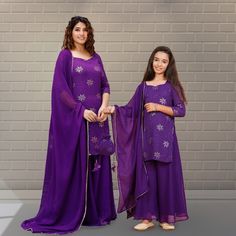 Mother's Salwar Kameez:-Faux Georgette Pakistani Suit in Violet This Readymade attire with Cotton Lining is Enhanced with Resham, Sequins Work and Tassels .Crafted in Sweetheart Neck and Quarter Sleeve. Available with a Faux Georgette Palazzo in Violet and a Faux Georgette in Violet The Kameez and Bottom Lengths are 40 and 43 inches respectively Do note: Accessories shown in the image are for presentation purposes only and length may vary upto 2 inches.(Slight variation in actual color vs. image Purple Gota Work Sets For Eid, Purple Sets With Gota Work For Eid, Long Sleeve Georgette Sets With Gota Work, Purple Gota Work Straight Kurta Sets, Purple Straight Kurta Sets With Gota Work, Purple Long Sleeve Sets With Mirror Work, Purple Straight Kurta Set With Mirror Work, Embroidered Purple Sets For Eid, Purple Chikankari Embroidery Sets For Festive Occasions