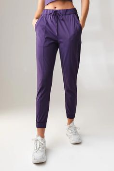 Our Nomad Jogger is designed to perform outdoors and on the go. This versatile high rise pant is a relaxed fit which offers functionality and comfort while also providing a sporty look to add to your wardrobe. Functional Tapered Leg Activewear With Side Pockets, Midweight Athleisure Bottoms With Functional Pockets, Athleisure Pants With Elastic Waistband For Outdoor, Versatile Activewear With Tapered Leg And Side Pockets, Versatile Activewear With Side Pockets And Tapered Leg, Athleisure Bottoms With Functional Pockets In Recycled Polyester, Sporty Relaxed Fit Pants In Recycled Polyester, Stretch Athleisure Joggers For Outdoor, Outdoor Activewear Long Pants With Side Pockets