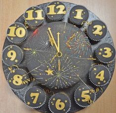 a clock made out of cupcakes with numbers and fireworks on the front side