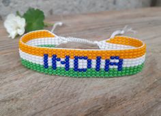 "Loom beaded bracelet with India flag. Patriotic hand woven beaded wristband with country symbol is a great gift for a women, girl or child for birthday, Christmas, Valentine's Day and other holidays. Small frienship memorable gift for best friend.  The armlet suitable for daily wear. Bracelet in stock and ready to ship. Other bracelets with flags here: https://www.etsy.com/shop/BeadSeeShop?ref=seller-platform-mcnav&section_id=36120104 More bracelets here: https://www.etsy.com/shop/BeadSeeShop?r Country Symbols, Flag Bracelet, Native Print, Patriotic Jewelry, Native American Bracelets, India Flag, Loom Bracelet Patterns, Blue Beaded Bracelets, Loom Bracelet