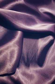 a close up view of a shiny purple fabric