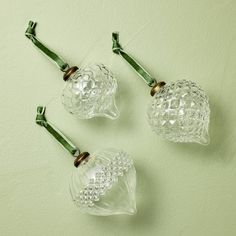 three clear glass vases sitting on top of a table