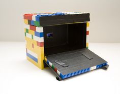 an open box made out of legos sitting on a table with the lid closed