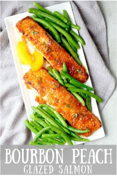 two fish fillets on a plate with green beans