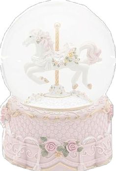 a snow globe with a horse on top and pink roses in the bottom, sitting on a stand