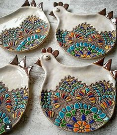 four ceramic birds with colorful designs on them