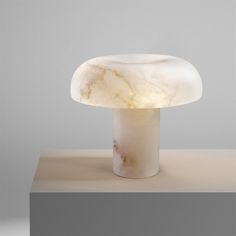 a white table lamp sitting on top of a counter