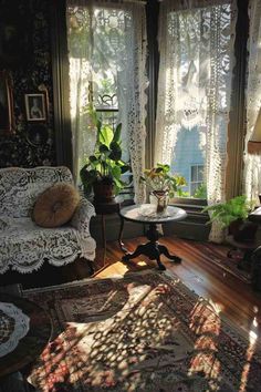 the sun shines through two windows into a living room with couches and rugs