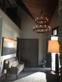 a chandelier hanging from the ceiling in a living room