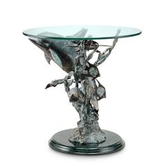 a glass and metal table with a dolphin on it