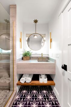 a bathroom with a sink, mirror and towel rack