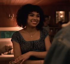 a woman standing next to a man in a kitchen smiling at the person he is talking to