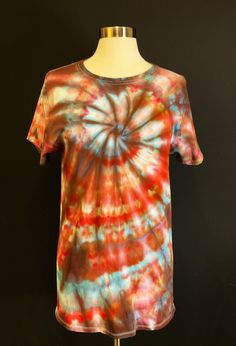 Medium ice dyed unisex short sleeve crew neck t shirt with spiral in blue, red, and orange. Cotton tie dye top.  I used a brand new white Fruit of the Loom t shirt for this design.  I use only the finest quality fiber reactive procion dyes from Dharma Trading Company, so the colors will last for years to come. You can safely wash this in the washing machine. It has been laundered twice in the dye process. I have done tie dye for years, but the pandemic gave me the opportunity to really delve into the craft, and I have found that I really enjoy ice dye. My Barcardi Kitty probably helped me tie your item, as she can't resist the kite string I use. I call her my artistic mews (get it? muse).  My items are dyed one at a time by me. These are not mass produced items being resold. I try to find Red Bohemian T-shirt For Spring, Bohemian Red Cotton T-shirt, Hand Dyed Short Sleeve Tops For Summer, Summer Acid Wash Hand Dyed T-shirt, Hippie Multicolor Short Sleeve T-shirt, Multicolor Short Sleeve Hippie T-shirt, Red Bohemian Cotton T-shirt, Summer Hand Dyed Short Sleeve T-shirt, Casual Hand Dyed Red T-shirt