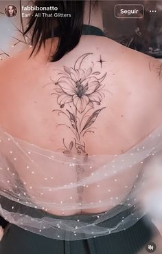 the back of a woman's shoulder with flowers on it