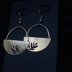 A beautifully handcrafted addition to your jewellery collection, these unique Fern Earrings will add a touch of sophisticated elegance to any look. Crafted from half moon brass and featuring a hand sawed fern design, these earrings are expertly finished with a surgical steel ear hook, providing ultimate comfort and a timeless classic style. Jewelry Sawing Design, Metal Stamped Earrings, Semi-circle Brass Earrings For Gifts, Bohemian Half Moon Metal Earrings, Handmade Half Moon Earrings, Metal Semi-circle Hoop Earrings For Pierced Ears, Handmade Metal Earrings Nature-inspired, Handmade Metal Earrings With Nature-inspired Style, Handmade Brass Half Moon Jewelry