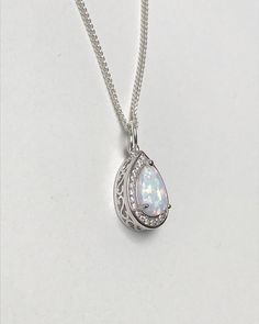 Sterling Silver White Fire Opal Necklace Metal: All Components Are Made From Solid .925 Sterling Silver Stone: Lab created Opal and CZ Measurement: pendant height is 15mm Choose Chain Length At Checkout Please feel free to Convo me with any questions before purchasing. Please view policy before purchasing Other Opal Necklaces can be found here https://www.etsy.com/shop/LinksAndStones?ref=ss_profile&section_id=24284450 Thank You For Visiting My Shop Silver Teardrop Jewelry With Stone Setting, White Gold Teardrop Necklace, Classic Sterling Silver Drop Necklace For Wedding, Wedding Teardrop Pendant Necklace With Birthstone, Sterling Silver Teardrop Pendant Jewelry, Sterling Silver Teardrop Jewelry With Stone Setting, White Gold Teardrop Necklace Hallmarked, Silver Drop Necklace With Cubic Zirconia, Silver Necklaces With Stone Setting For Anniversary