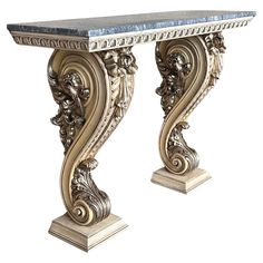 an ornate console table with marble top