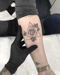 a person with a rose tattoo on their arm