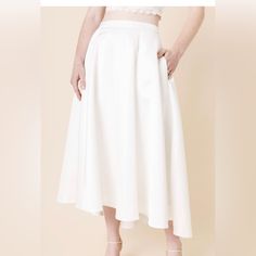 - Length 32" / Waist 28" - Measured From A Size S. - 100% Polyester - Hand Wash Cold Water; Lay Flat To Dry. - Non-Stretch - Models Are Approximately 5’10” And Wear A Size Small You'll Feel Romantic And Effortlessly Stylish In This Side Pocket Wedding Skirt. This High-Low Skirt Looks Amazing With A Lace Tank Top As The Perfect Bridal Outfit For Your Special Events. White A-line Formal Bottoms, White Fitted A-line Bottoms, Chic A-line Wedding Skirt, White Midi Skirt For Evening, White Evening Midi Skirt, Spring Wedding A-line Skirt, White Flared Evening Skirt, White Flowy A-line Skirt, White A-line Flowy Skirt