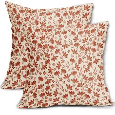 two red and white pillows with leaves on them