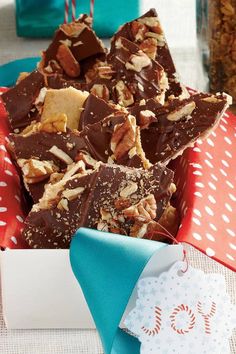 a box filled with chocolate and nuts on top of a table