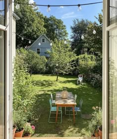 an open window shows a table and chairs in the yard