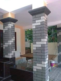 a living room filled with furniture and brick pillars