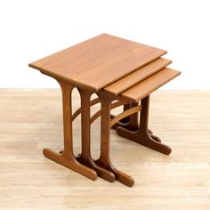 two wooden tables sitting on top of a hard wood floor