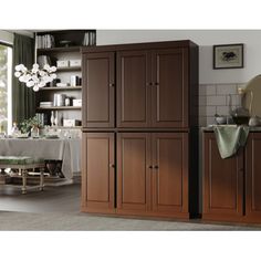 a kitchen with wooden cabinets and white table cloth