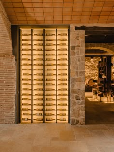 an open door with wooden slats in front of a brick wall and stone floor