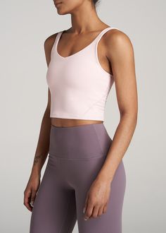 About Our Long Crop Top Quality women's tall tank tops are hard to come by – which is why you'll want this tank from our AT Balance line in every color. With a cropped length that ends just above the natural waist, a scoop back and a fitted style that will flatter your frame, it can be worn everywhere from the Pilates studio to the yoga mat and brunch with friends. This cropped tank top is made of a buttery-soft fabric that's sweat-wicking and lightweight so you can stay comfortable while you wo Solid Color Tank Top With Medium Support, Bra-friendly Gym Cami Tops, Sleeveless Tops With Built-in Bra And Medium Support, Medium Support Tank Top, Sports Tank Camisole, Fitted Cami Tops For Sports, Fitted Camisole Top For Gym, Yoga Cami Top With Medium Support, Medium Support Cami Top For Yoga