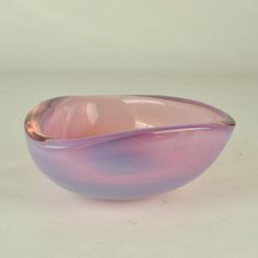 a purple bowl sitting on top of a white table