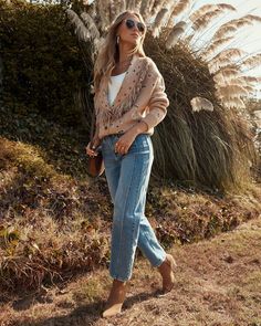 Bring on the cozy vibes with the Amber Trails Printed Fringe Trim Cardigan. Featuring soft knit fabric and a playful fringe trim along the lapel, this cardigan adds just the right touch of boho charm. The front button closure gives you the option to wear it open for a laid-back look or buttoned up for extra warmth. Whether you're lounging at home or heading out for holiday gatherings, this cardigan is ideal for effortless style with a relaxed, cozy feel. Soft knit fabric Fringe trim lapel Front button closure Ribbed cuffs and hem 60% Viscose 26% Polyester 14% Nylon Bohemian V-neck Cardigan For Fall, Fall Bohemian V-neck Cardigan, Spring Fringe Long Sleeve Cardigan, Spring Long Sleeve Fringe Cardigan, Bohemian V-neck Cardigan For Winter, Chic Fringe Cardigan, Knit Fringe Outerwear For Fall, Bohemian Long Sleeve Outerwear With Frayed Hem, Knit Outerwear With Fringe For Fall