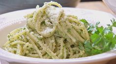 a white bowl filled with pasta and parsley