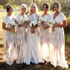 a group of women standing next to each other in front of a field with palm trees