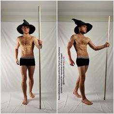 a man with no shirt holding a stick and wearing a black hat on his head