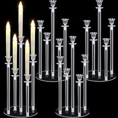 six candles are lined up in clear glass holders